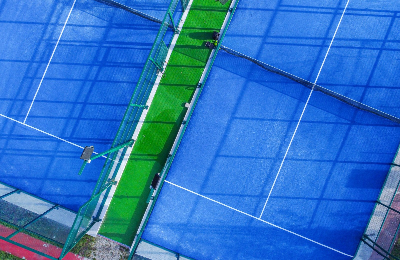 An aerial view of a part of two paddle tennis courts