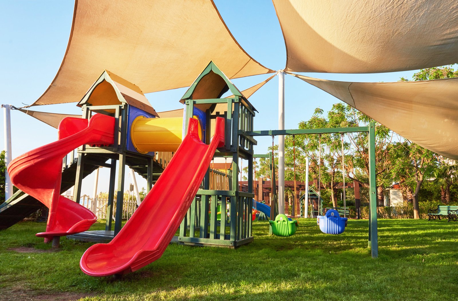 Colorful playground in the yard in the park at sunset