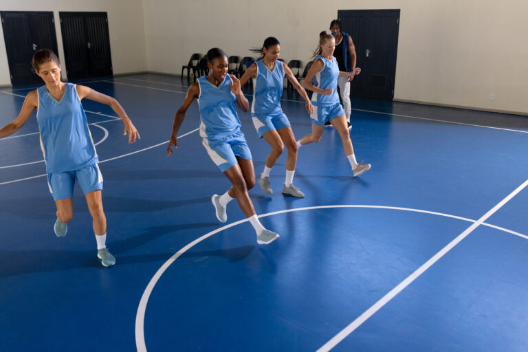 Female basketball team practicing drills on indoor court, focusing on coordination, copy space. teamwork, practice, exercise, training, athletics, fitness