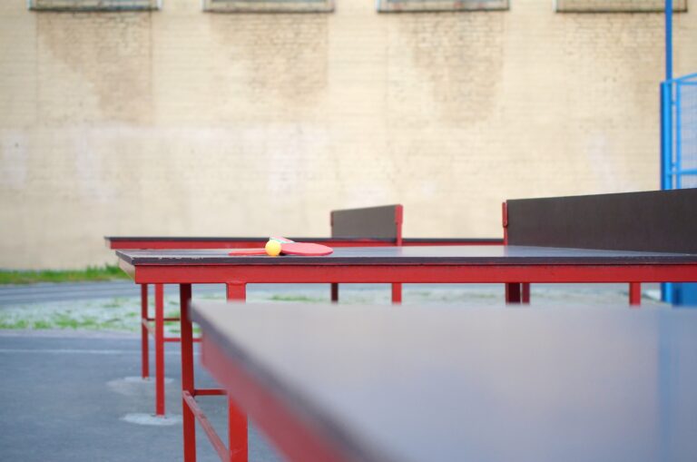 rackets and ball close up on Ping pong table in outdoor sport yard. Active sports and physical training concept