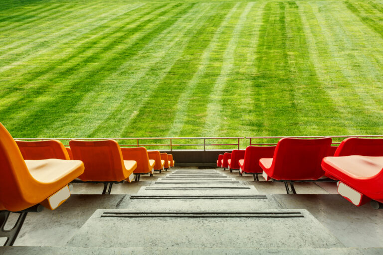 red-seats-and-green-grass-in-the-stadium-2026-01-11-09-01-10-utc