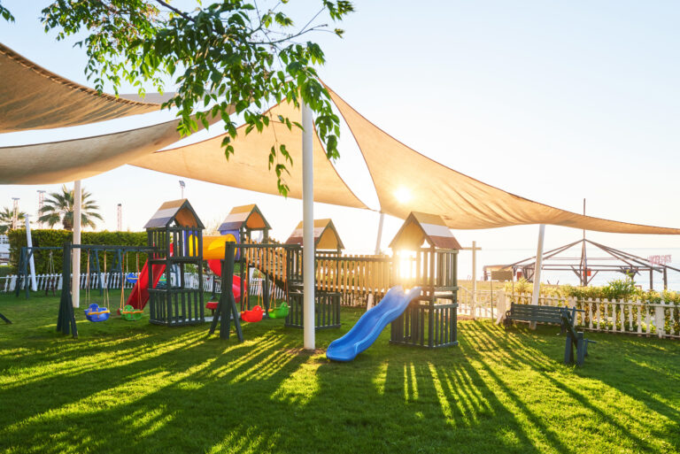Colorful playground in the yard in the park at sunset