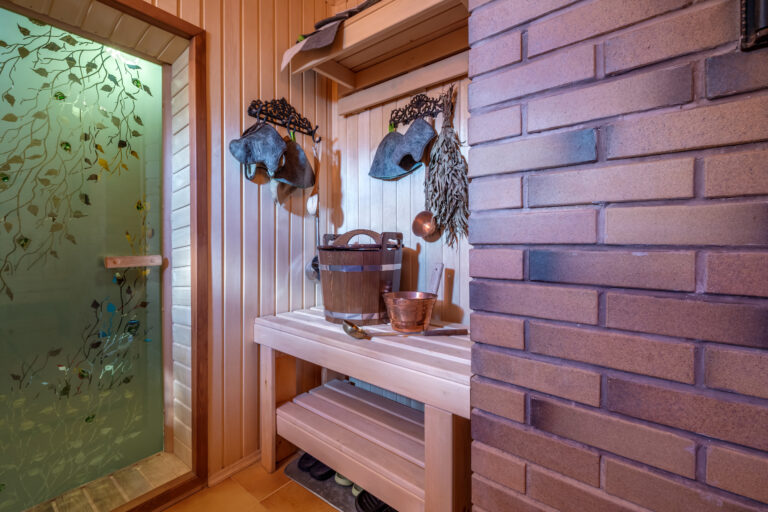 standard design classic wooden russian bath sauna interior with hot stones