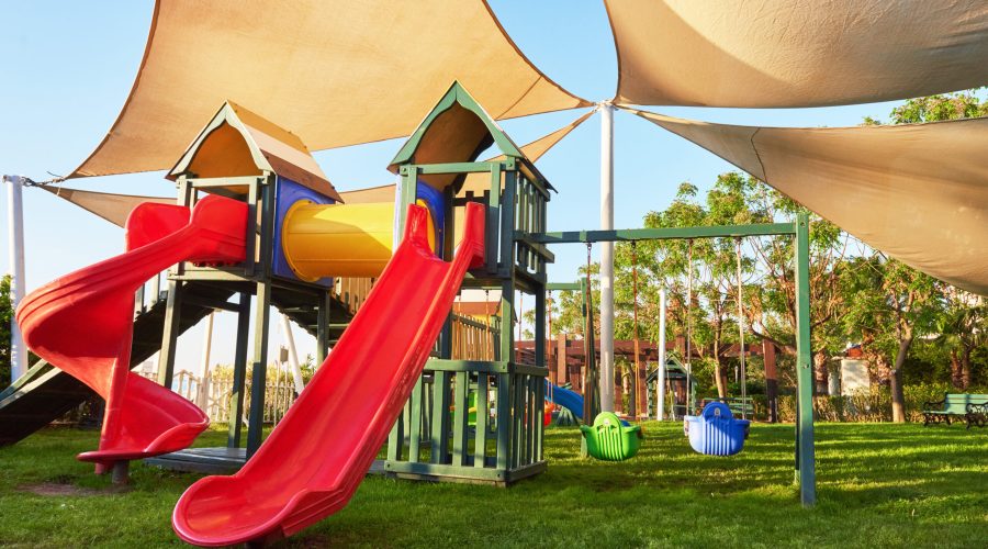 Colorful playground in the yard in the park at sunset