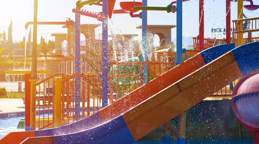 Colorful slides in waterpark close up. Aquapark sliders with pool