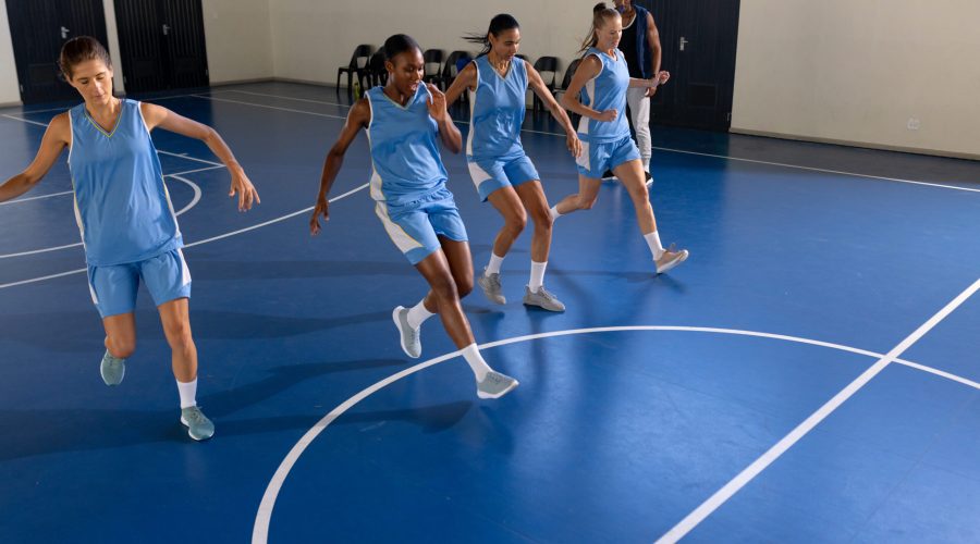 Female basketball team practicing drills on indoor court, focusing on coordination, copy space. teamwork, practice, exercise, training, athletics, fitness