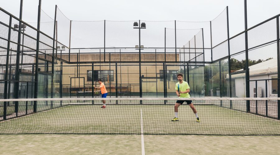 two young man playing paddle tennis